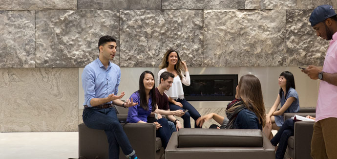 Students in front of the atrium fireplace