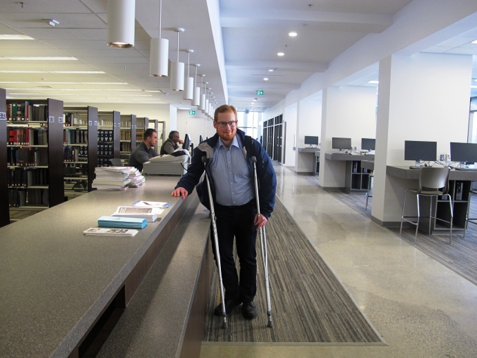 Law student Spencer Robinson by the reference desk after entering the library
