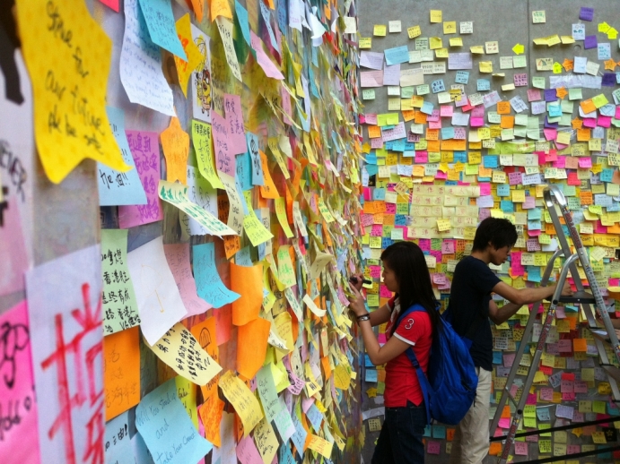 Sticky note messages paper a large wall in support of Hong Kong protesters