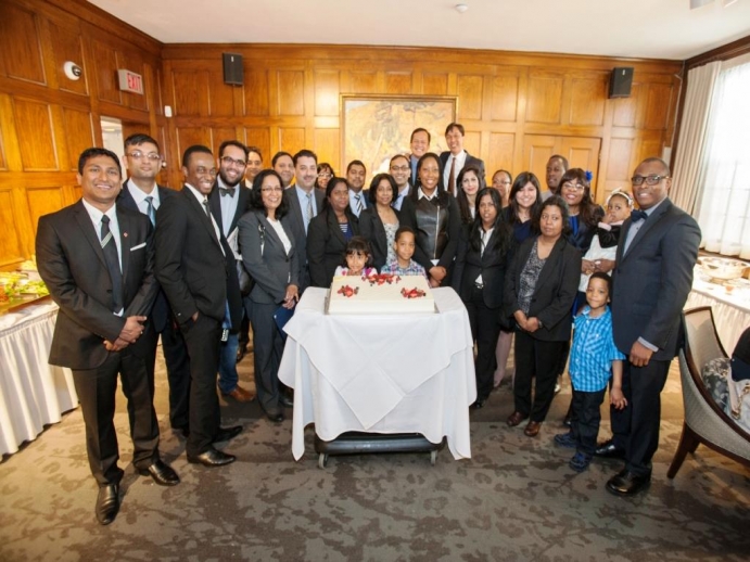 Group shot of 30 internationally trained lawyers celebrating their program completion with lunch and cake