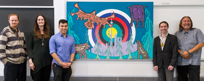 (L-R) Douglas Varrette, Natalie Day, Joshua Favel and Zachary Biech stand with Artist Jay Bell Redbird and his new painting A Meeting Place for All Our Relations