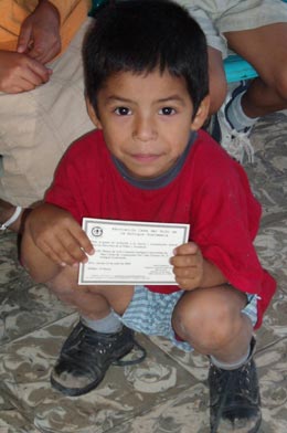 A child from the local orphanage holding his invitation to the Conference on the Rights of Children and Youth