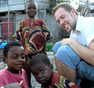 Travis Allan with kids from the school run by United Action for Children