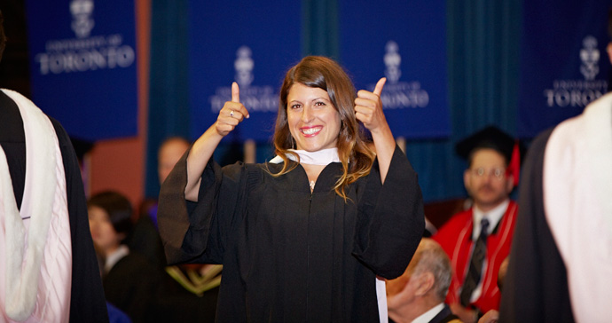 Newly graduated student giving thumbs-up