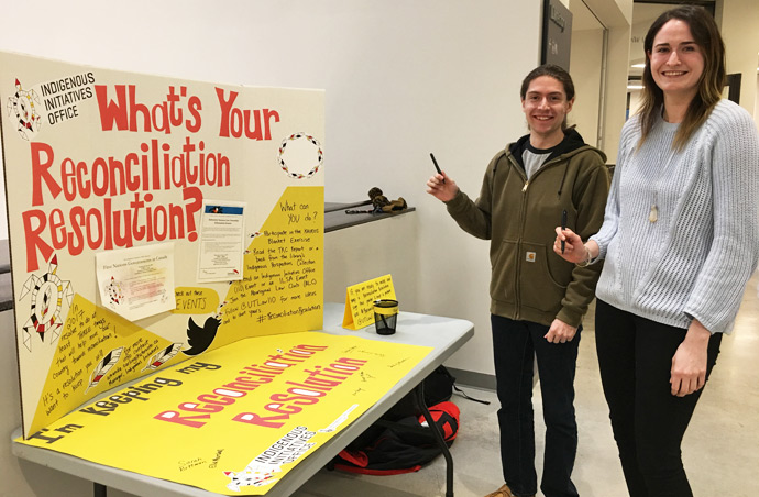 First year law students and members of the Indigenous Law Students' Association Zachary Biech and Natalie Marsh prepare to commit to their Reconciliation Resolutions.