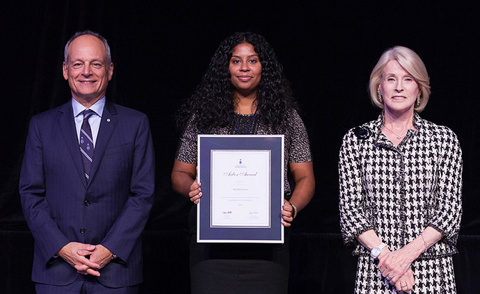 Atrisha Lewis, J.D. 2012 (centre) with her Arbor Award, flanked by U of T President Meric Gerler (left) and U of T Chancellor Rose Patten (right)