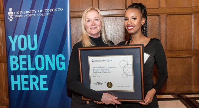 Ifrah Farah (right) receiving scholarship award