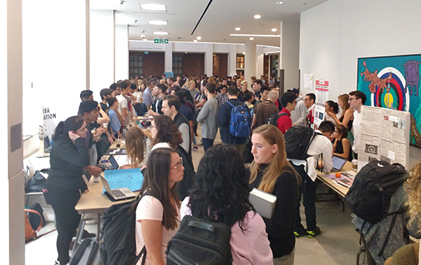 Students at clubs fair in atrium of Jackman Law Building