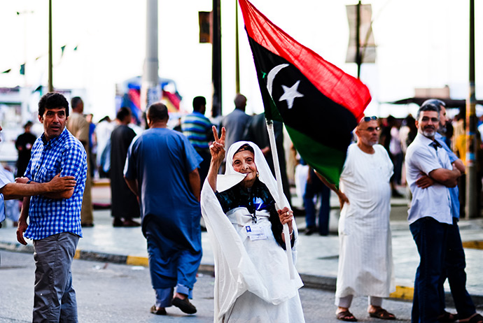 Libyian woman holding flag