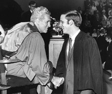 The Hon. Laskin congratulates a young John I. Laskin 69 at his graduation.