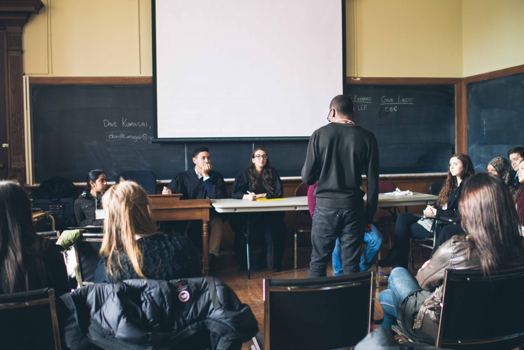 Students participate in mock trial in classroom setting with attendees