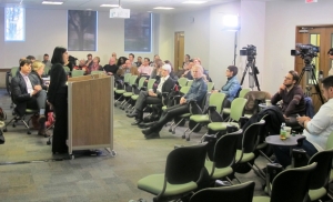 Prof. Yasmin Dawood speaks as cameras record the panel discussion