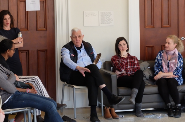 Elder Bob Phillips talks to students and passes an eagle feather