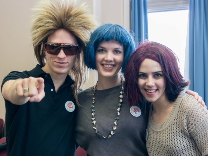 Three students in outrageous wigs, laughing
