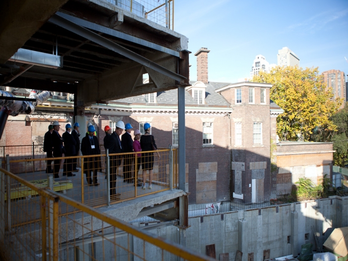 Alumni overlooking the construction pit on the second floor towards Queen's Park crescent