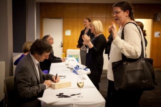 Authors signing their books after the panel.