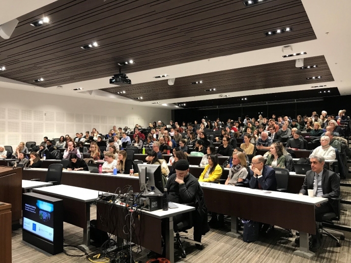 full house in Moot Court room, view from the front of the room, for panel discussion on darker side of digital