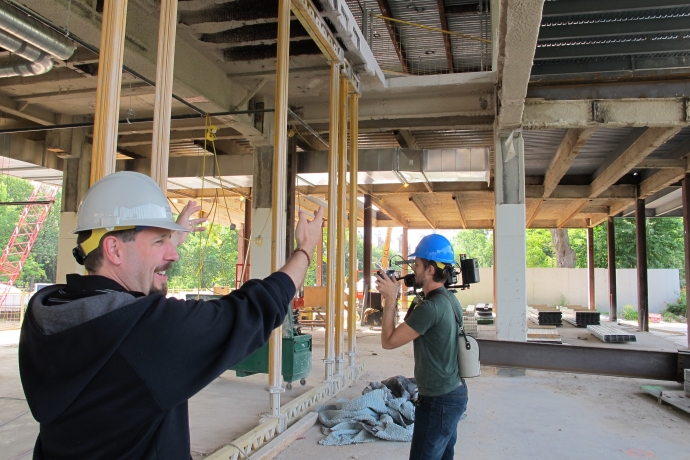 Sean Ingram indicating where stairway to second floor will be in construction site