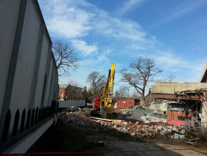 Excavator with shears tearing down Moot Court