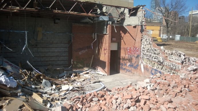 last standing wall of the moot court debris all around 