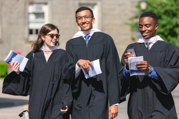 three-shop of a femail and two male law graduates in their robes at June 2018 convocation