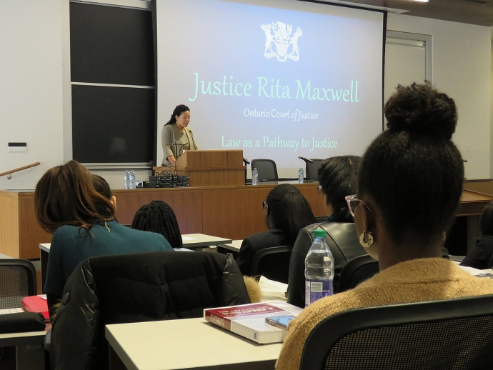 Alumna Justice Rita Maxwell presenting in front of group of black students
