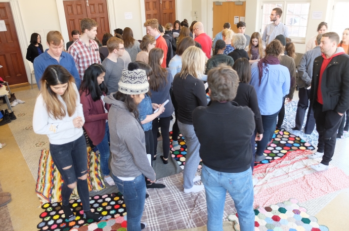 students faculty staff participating in blanket exercise, walking on blankets