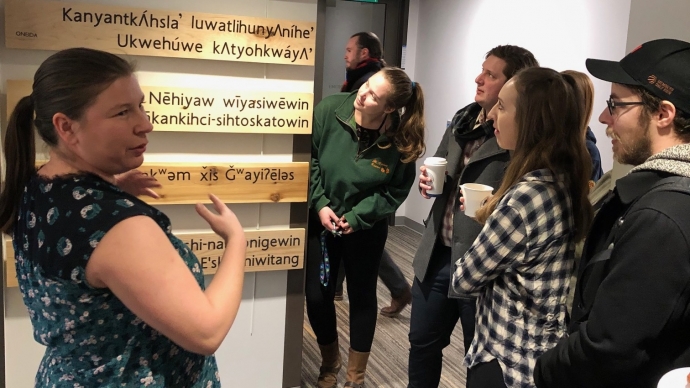 Rochelle Allan, left, acting manager of the Indigenous Initiatives Office and law students view the language art installation