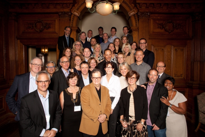 Group shot of Class of 1989 alumni on the steps of fireplace lounge in Flavelle House