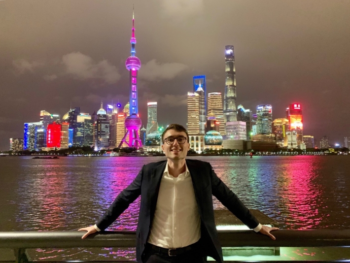 law student james flynn with night time Shanghai skyline behind him