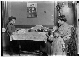 black and white image of turn of the century mother working at home menial labour