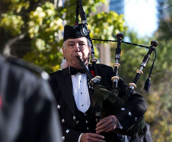 Person playing bagpipes.